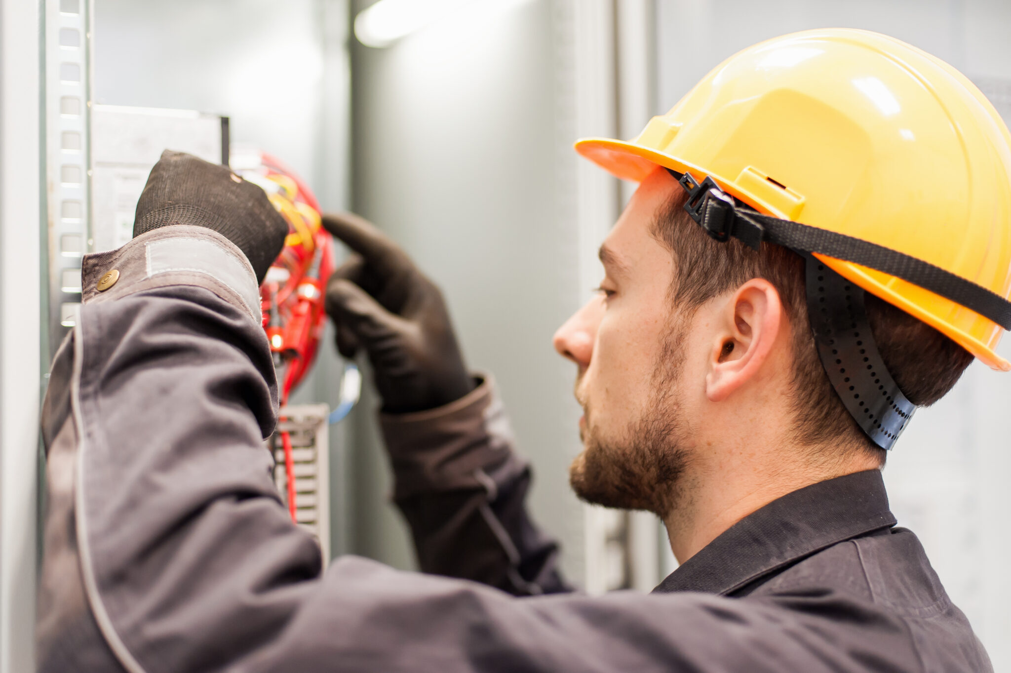 Closeup of electrician engineer works with electric cable wires